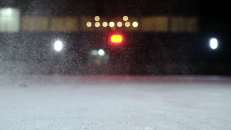 Close-up-of-the-puck-is-on-the-ice-and-in-slow-motion-hockey-player-pulls-up-and-the-snow-flies-into-the-camera-and-he-takes-the-puck-stick